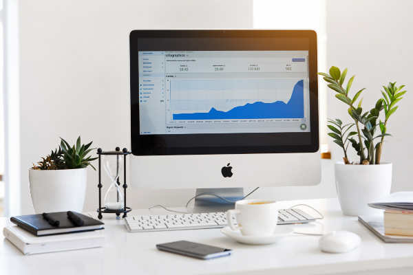 Chart showing increased website visitors on an iMac computer