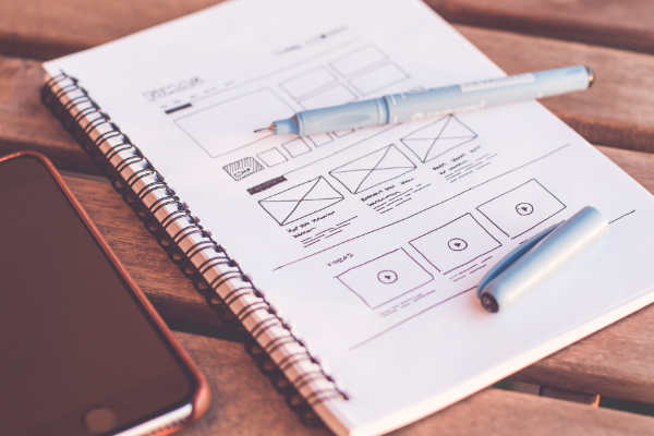 Notepad with web design sketch